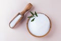 Natural sweetener in a wooden bowl on a pink background. Sugar substitute. Erythritol. Royalty Free Stock Photo