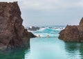 Natural swimming pool pond with ocean wave breaking sea water on background Royalty Free Stock Photo