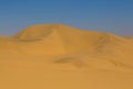 Tall sand dune in Namib desert, blue sky