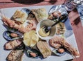 Tasty assorted seafood on the plate in the restaurant in Portugal