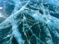 The natural texture of winter ice with white bubbles and cracks on a frozen lake. Abstract background of ice and cracks on the Royalty Free Stock Photo
