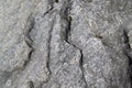 Natural textured relief grey background. Rough, uneven, irregular granite stone surface