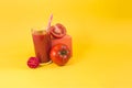 Natural tomato juice in a glass container with a decor of tomatoes, salt and a colored cube Royalty Free Stock Photo