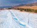 Natural travertine pools blue water in Pamukkale Turkey drone aerial top view