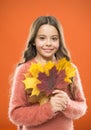 Natural treasures. Collecting leaves. Changes in nature. Cute happy smiling kid playing with leaves. Fall symbol. Happy