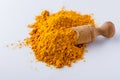 Natural turmeric powder on white acrylic background