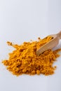 Natural turmeric powder on white acrylic background