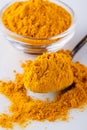 Natural turmeric powder on white acrylic background