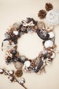 A Natural Twig Wreath Decorated with Pine Cones, Stars, and Bows. Vertical image. Cristams and Winter Concept. Royalty Free Stock Photo