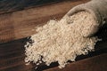 Natural unpolished brown rice on wooden table. healthy food and eating concept