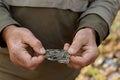 Natural unprocessed pieces of mica minerals in the hands of a man in a natural deposit