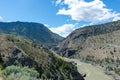 Natural view of beautiful river flowing through mountain gorge on sunny day under blue cloudy sky Royalty Free Stock Photo