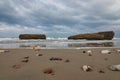 Natural view of small stones on a sandy beach under a cloudy sky background Royalty Free Stock Photo