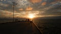 Sunset With Silhouettes Of People Standing On The Pier Royalty Free Stock Photo