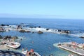 Natural volcanic lava swimming pools on a sunny day with blue sky and Atlantic Ocean in Porto Moniz in Madeira Island, Portugal Royalty Free Stock Photo