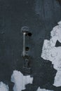 Old rusty slim handle on a retro door. Old door knob on vintage texture. Peeling paint. Royalty Free Stock Photo