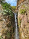 Natural Water fall between mountains on roadside Royalty Free Stock Photo