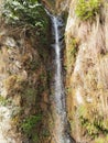 Natural Water fall between mountains on roadside Royalty Free Stock Photo