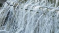 Natural water spring with multiple pipes expelling water in the mountain