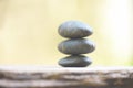 Natural wellness concept - Relax zen stones stack on wooden nature green background Spa Natural Alternative Therapy With Massage