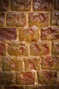 Wet weathered orange brick wall texture made of stone with vignette. background, architecture. Royalty Free Stock Photo