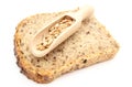 Natural wheat grain on wooden spoon and slice of bread Royalty Free Stock Photo