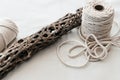 Natural white macrame cord with dry cholla stick on soft white background