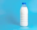 Natural white milk in plastic bottle on blue background with copyspace selective focus Royalty Free Stock Photo