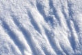 Natural winter snowy background. Winter uneven snow surface of freshly fallen fluffy snow diagonal orientation.