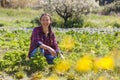 Natural woman working in sunny sustainable garden Royalty Free Stock Photo