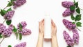 Natural women`s hand cosmetics made from flowers and lilac petals. Moisturize and soften your hands. female hands hold cream on