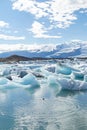 Natural wonder of Iceland. Amazing view of Icebergs and ice floes floating in a large Jokulsarlon glacier lagoon Royalty Free Stock Photo