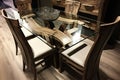 natural wood dining room set with glass tabletop and metal accents