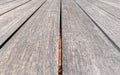 Natural wood dock planks converging perspective lines closeup.