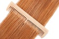 natural wood hair comb on hair on white isolated background