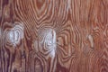 Natural wood texture with a florid pattern and many patched knot holes.