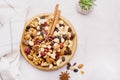 Natural wooden bowl with assortment nuts, raisins and cranberries from above. Aesthetics walnuts, almonds, hazelnuts and Royalty Free Stock Photo