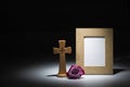 Natural wooden picture frame with wooden crucifix and pink rose Royalty Free Stock Photo