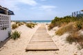 Natural wooden walkway on beach on the sand on the way to the sea Royalty Free Stock Photo