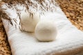 Natural wool dryer balls for more soft clothes while tumble drying in washing machine concept.