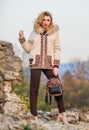 Natural wool sheepskin coat. Fur on hood. Hit of season. Stay warm and fashionable. Woman wear furry coat. Winter