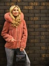 Natural wool sheepskin coat. Fur on hood. Stay warm and fashionable. Glamorous lady. Woman wear furry coat. Winter