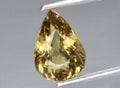 Natural yellow beryl heliodor gem on the background