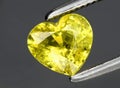 Natural yellow chrysoberyl gem on the background Royalty Free Stock Photo