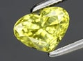 Natural yellow chrysoberyl gem on the background Royalty Free Stock Photo