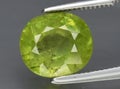natural yellow green grossular garnet gem on the background