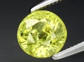 natural yellow green grossular garnet gem on the background