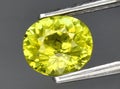 natural yellow grossular garnet gem on the background