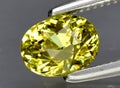 Natural yellow grossular garnet gem on the background