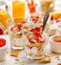 Natural yogurt with fresh fresh strawberries, granola, honey, nuts and seeds in a glass dishes. Delicious breakfast or dessert. Royalty Free Stock Photo